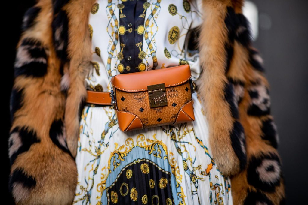 Zara, Yves Salomon, MCM, Christian Louboutin, Gucci Alexandra Lapp in a Pattern Mix wearing a pleating chain patchwork print skirt and a matching shirt from Zara, a short fur jacket from Yves Salomon with an animal print, Metrisandal open-toe sandals from Christian Louboutin with tape-style straps, the Soft Berlin Belt Bag in Visetos by MCM in cognac and the Gucci cat-eye radiant ivory sunglasses during Paris Fashion Week Womenswear Spring/Summer 2019 on September 24, 2018 in Paris, France.