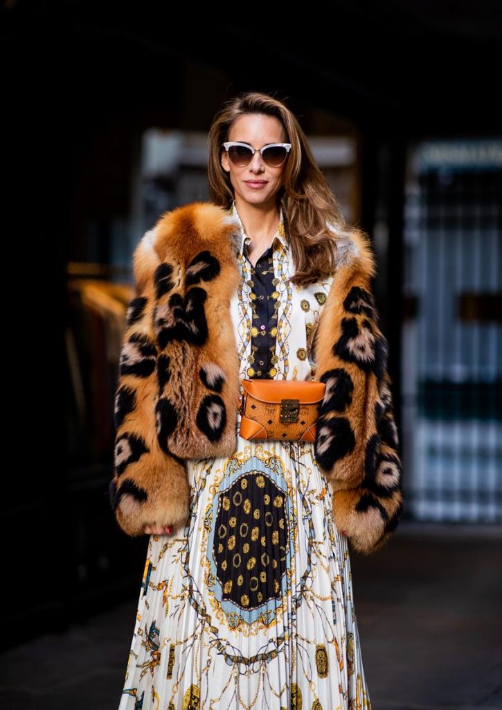 Zara, Yves Salomon, MCM, Christian Louboutin, Gucci Alexandra Lapp in a Pattern Mix wearing a pleating chain patchwork print skirt and a matching shirt from Zara, a short fur jacket from Yves Salomon with an animal print, Metrisandal open-toe sandals from Christian Louboutin with tape-style straps, the Soft Berlin Belt Bag in Visetos by MCM in cognac and the Gucci cat-eye radiant ivory sunglasses during Paris Fashion Week Womenswear Spring/Summer 2019 on September 24, 2018 in Paris, France.