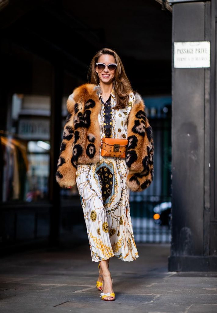 Zara, Yves Salomon, MCM, Christian Louboutin, Gucci Alexandra Lapp in a Pattern Mix wearing a pleating chain patchwork print skirt and a matching shirt from Zara, a short fur jacket from Yves Salomon with an animal print, Metrisandal open-toe sandals from Christian Louboutin with tape-style straps, the Soft Berlin Belt Bag in Visetos by MCM in cognac and the Gucci cat-eye radiant ivory sunglasses during Paris Fashion Week Womenswear Spring/Summer 2019 on September 24, 2018 in Paris, France.