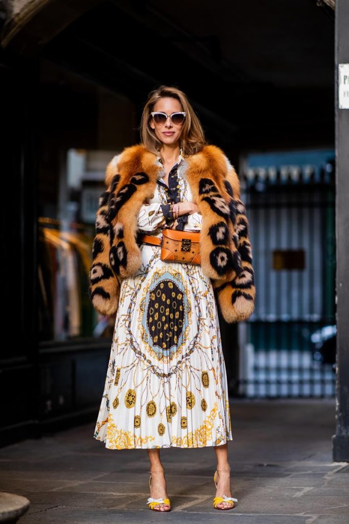 Zara, Yves Salomon, MCM, Christian Louboutin, Gucci Alexandra Lapp in a Pattern Mix wearing a pleating chain patchwork print skirt and a matching shirt from Zara, a short fur jacket from Yves Salomon with an animal print, Metrisandal open-toe sandals from Christian Louboutin with tape-style straps, the Soft Berlin Belt Bag in Visetos by MCM in cognac and the Gucci cat-eye radiant ivory sunglasses during Paris Fashion Week Womenswear Spring/Summer 2019 on September 24, 2018 in Paris, France.