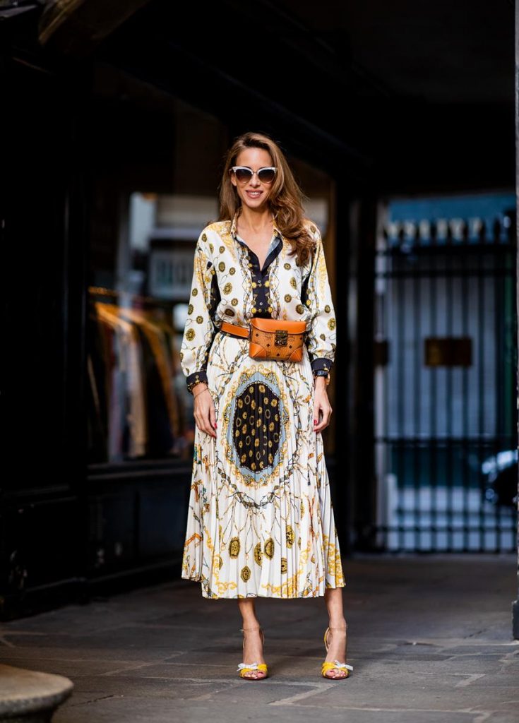 Zara, Yves Salomon, MCM, Christian Louboutin, Gucci Alexandra Lapp in a Pattern Mix wearing a pleating chain patchwork print skirt and a matching shirt from Zara, a short fur jacket from Yves Salomon with an animal print, Metrisandal open-toe sandals from Christian Louboutin with tape-style straps, the Soft Berlin Belt Bag in Visetos by MCM in cognac and the Gucci cat-eye radiant ivory sunglasses during Paris Fashion Week Womenswear Spring/Summer 2019 on September 24, 2018 in Paris, France.