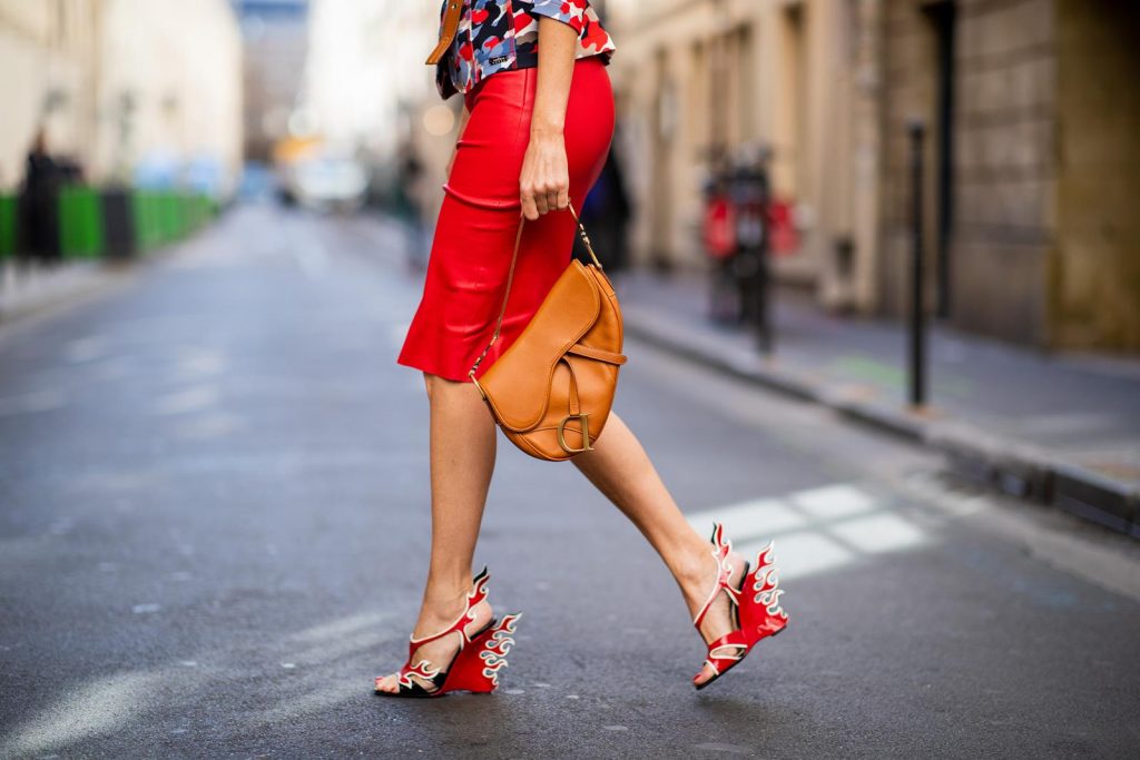 Alexandra Lapp in a Prada Flame Sandals / Graphic Pattern Look wearing a Cindy Blazer with graphic pattern by Airfield, a red leather pencil skirt by American Retro, red flame wedge sandal heels from Prada and a vintage Dior saddle bag in cognac, Gucci cat-eye radiant ivory sunglasses and brown cognac soft leather belt by Prada is seen during Paris Fashion Week Womenswear Spring/Summer 2019 on September 25, 2018 in Paris, France.