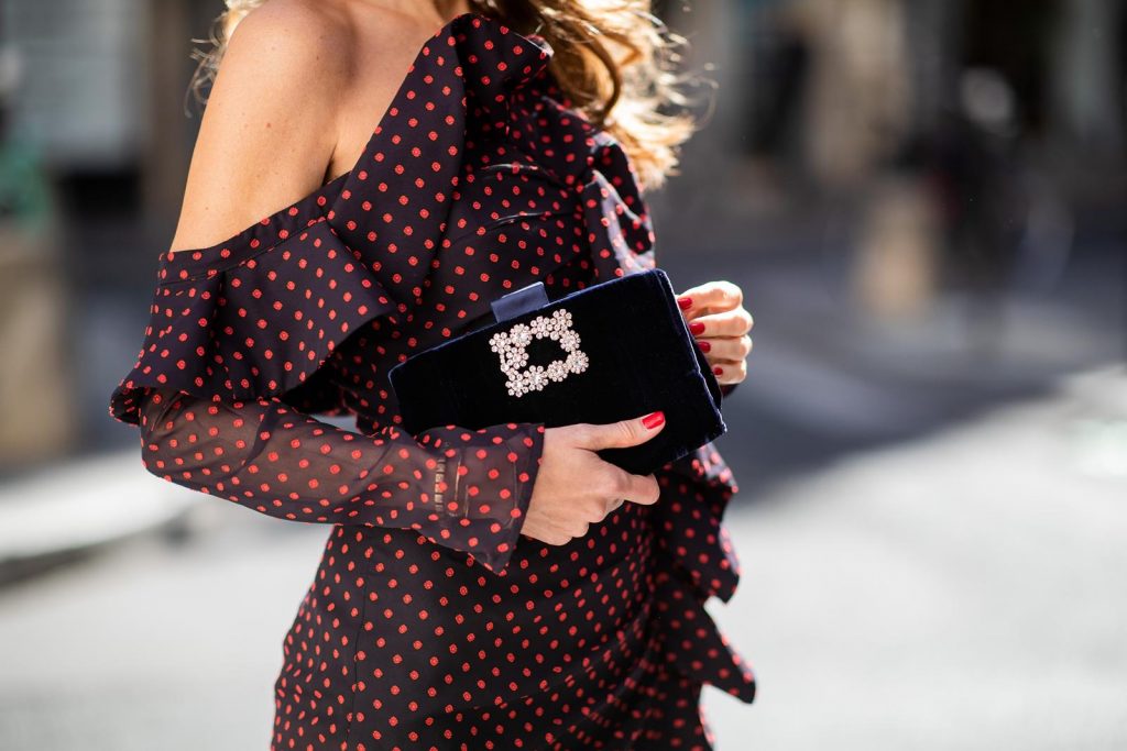 Alexandra Lapp in a One Shoulder Mini Dress Look wearing an one-shoulder ruffled fil coupe chiffon mini dress by Self-Portrait, black leather heels black sequined in the back from Roger Vivier, black Soft Flowers Clutch in silk by Roger Vivier and red cat-eye shaped sunglasses from Celine during Paris Fashion Week Womenswear Spring/Summer 2019 on September 25, 2018 in Paris, France.