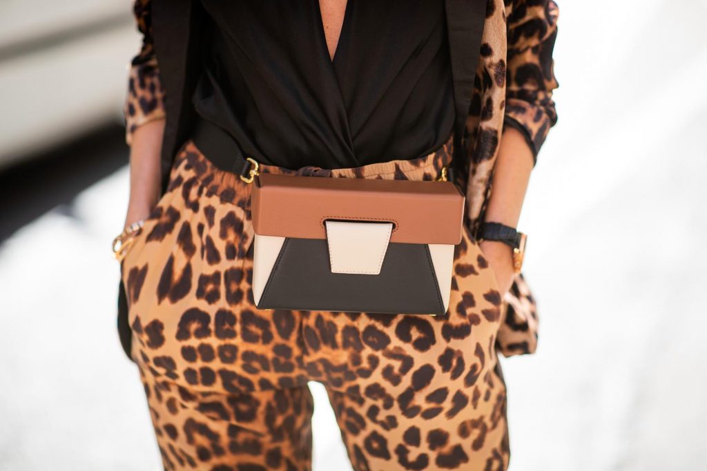 Alexandra Lapp in a Leo Print Look wearing a velvet blazer with a satin collar in leopard print with matching satin leopard print trousers from Jadicted, a black satin top from Balmain with a wide cut out, the Lola color-block belt bag from Yuzefi, black pumps from Christian Louboutin and a black Alessandria medium-brim felt hat from Borsalino during Paris Fashion Week Womenswear Spring/Summer 2019 on September 25, 2018 in Paris, France.