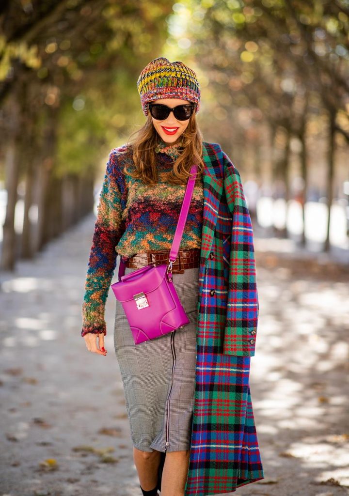 Alexandra Lapp in a Mixed Prints Look wearing a long multicolored plaid coat and a wool turtleneck multicolored sweater from Ouì, a black and white plaid slim cut skirt with a zipper up front from Ouì, a brown waist belt from Max Mara, black suede high heels from Christian Louboutin, the Soft Berlin Crossbody Bag in Viva Lilac from MCM, a multicolored wool hat from Missoni, purple black striped socks by H&M and the black Audrey sunglasses from Celine during Paris Fashion Week Womenswear Spring/Summer 2019 on September 25, 2018 in Paris, France.