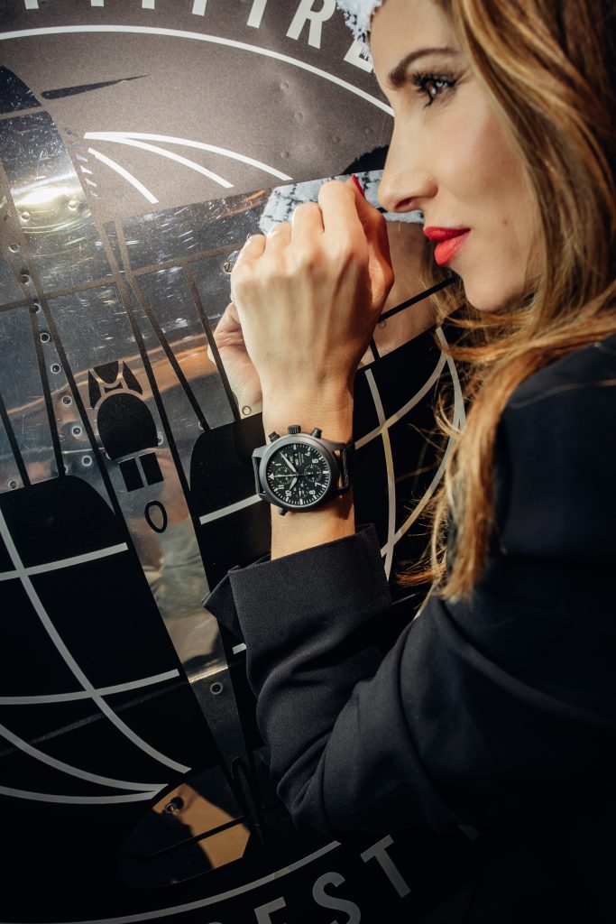 Alexandra Lapp in a Silver Spitfire Look, wearing a IWC Spitfire watch while visiting the IWC Schaffhausen booth at the SIHH 2019 in Geneva.