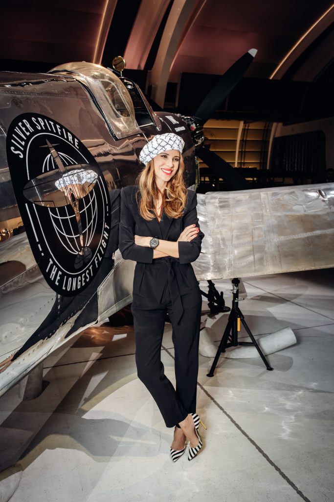 Alexandra Lapp in a Silver Spitfire Look, wearing a IWC Spitfire watch while visiting the IWC Schaffhausen booth at the SIHH 2019 in Geneva.