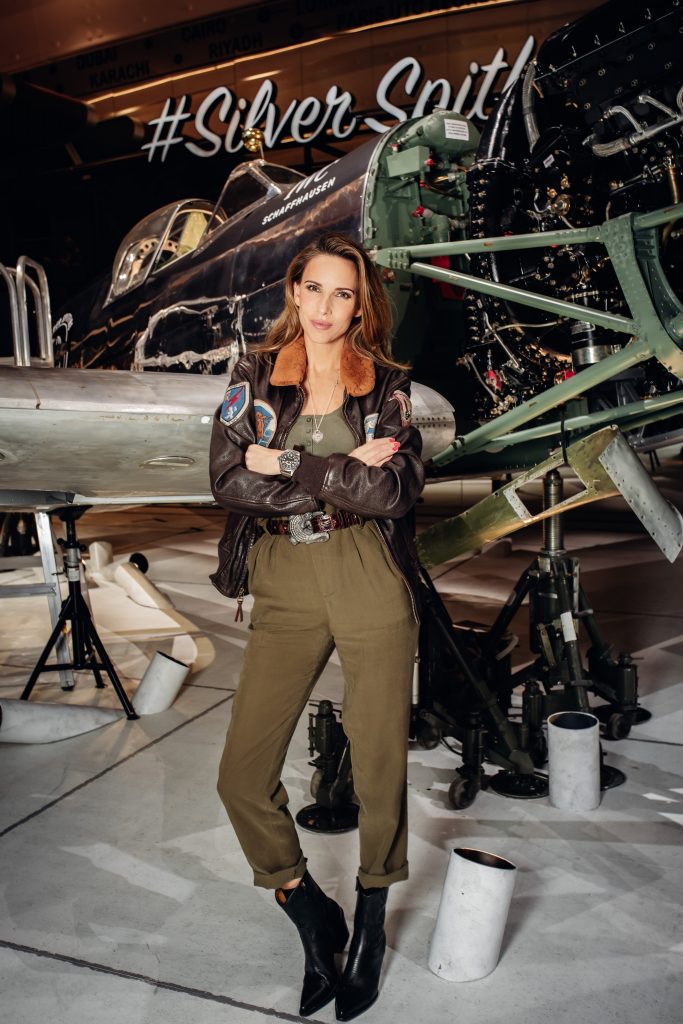 Alexandra Lapp in a Silver Spitfire Look, wearing a IWC Spitfire watch while visiting the IWC Schaffhausen booth at the SIHH 2019 in Geneva.
