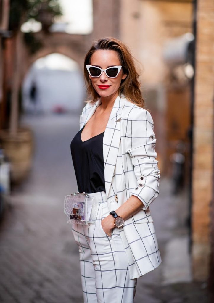 Alexandra Lapp in a ladysuit look, wearing the Pierre double-breasted checkered suit combination in black and white from Rebecca Vallance with matching high rise pants with a flared hem, a black top from Jadicted, black lacquer high heels with sparkling heels from Philipp Plein, a golden Portugieser Chronograph from IWC and a transparent waisted belt bag and white Saint Laurent New Wave 213 Lily sunglasses on November 25, 2018 in Marrakech, Morocco. (Photo by Christian Vierig/Getty Images)
