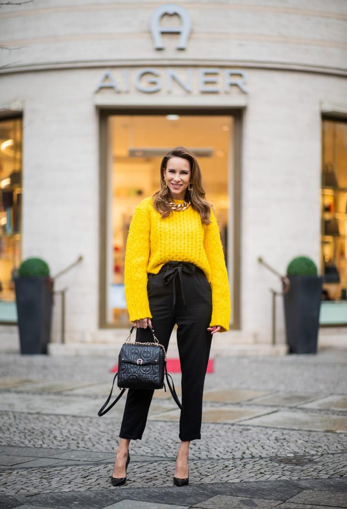 Alexandra Lapp in a Diadora Backpack look, wearing a cropped yellow cable knit sweater from R13 with paperbag pants from H&M, Gianvito Rossi patent leather pumps, Zara earrings and a H&M statement necklace and Aigner Diadora M backpack in during the Berlin Fashion Week Autumn/Winter 2019 on January 17, 2019 in Berlin, Germany. (Photo by Christian Vierig/Getty Images)