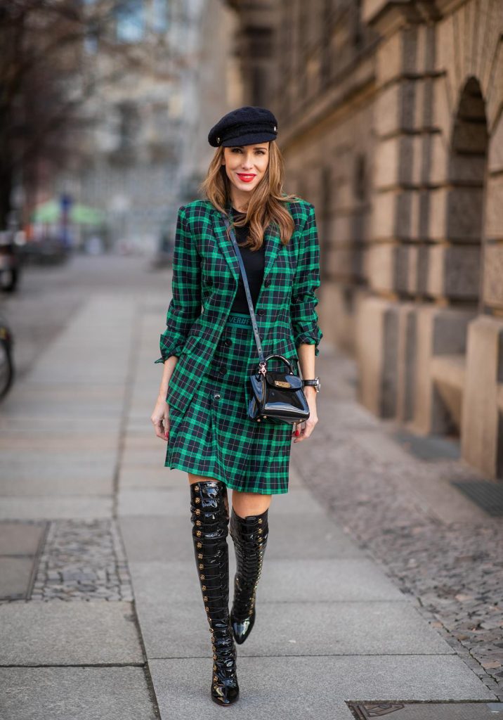 Alexandra Lapp in a checkered suit look, wearing a feminine green checkered Riani blazer with a matching pleated skirt, styled with a Vince knitted T-shirt, a black Chanel tweed baker boy cap, patent leather Louise over-the-knee boots from Christian Louboutin, and a ZAC Zac Posen patent Mini 'Eartha Iconic‘ bag during the Berlin Fashion Week Autumn/Winter 2019 on January 18, 2019 in Berlin, Germany. (Photo by Christian Vierig/Getty Images)