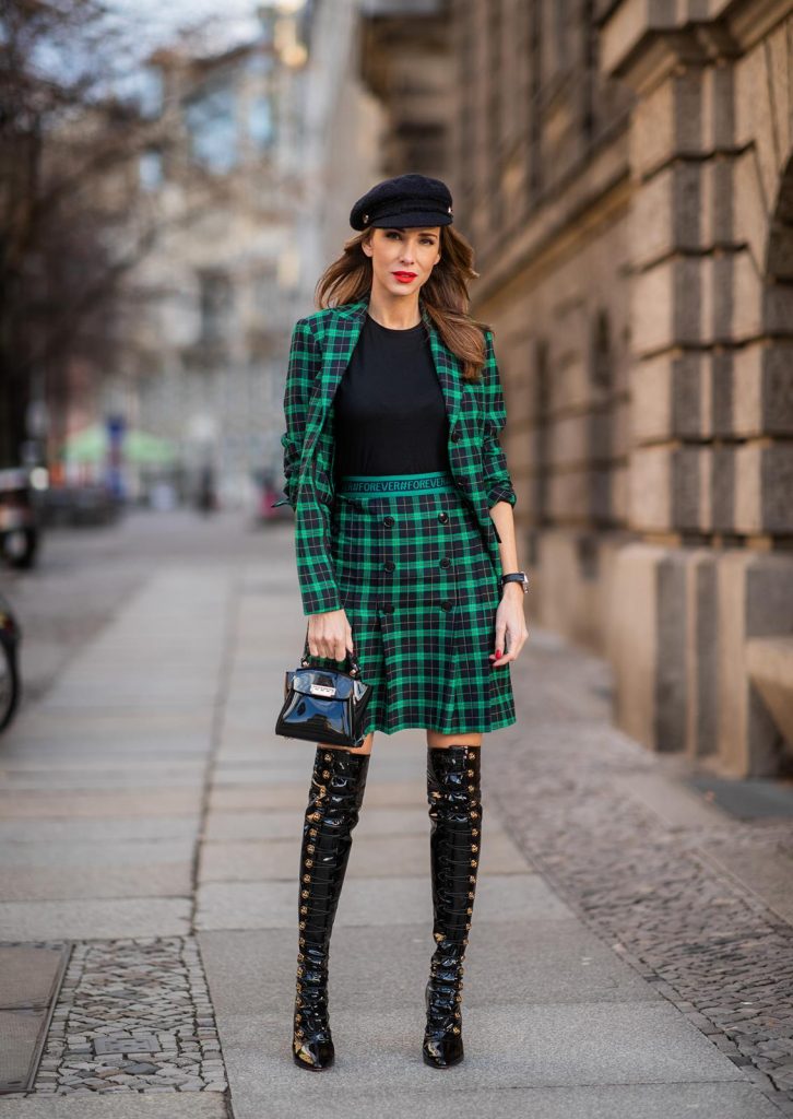 Alexandra Lapp in a checkered suit look, wearing a feminine green checkered Riani blazer with a matching pleated skirt, styled with a Vince knitted T-shirt, a black Chanel tweed baker boy cap, patent leather Louise over-the-knee boots from Christian Louboutin, and a ZAC Zac Posen patent Mini 'Eartha Iconic‘ bag during the Berlin Fashion Week Autumn/Winter 2019 on January 18, 2019 in Berlin, Germany. (Photo by Christian Vierig/Getty Images)