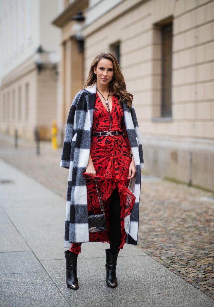  Alexandra Lapp in a Red Animal Print Look, wearing the long Adriana animal print dress from Rixo, a black and white wool coat from Ganni, the Isabel Marant Lamsy cowboy boots, a black boy bag from Chanel, a silver buckled H&M cowboy belt, a western cowboy necklace and red cat-eyed sunglasses by Celine during the Berlin Fashion Week Autumn/Winter 2019 on January 15, 2019 in Berlin, Germany. (Photo by Christian Vierig/Getty Images)