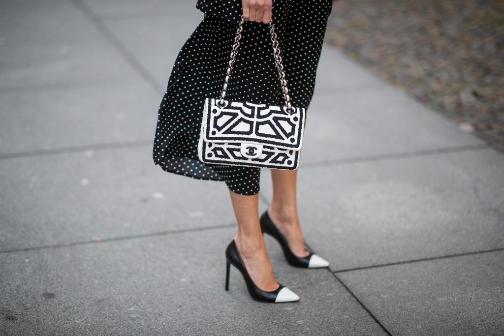 Chanel, Steffen Schraut, Manolo Blahnik Alexandra Lapp in a tweed beret dot suit look, wearing a long black blazer with dots and matching culotte pants, black and white striped sweater with a yellow detail from Steffen Schraut, a black and white tweed beret from the Chanel La Pausa collection, a black and white 2.55 flap bag from Chanel during the Berlin Fashion Week Autumn/Winter 2019 on January 16, 2019 in Berlin, Germany. (Photo by Christian Vierig/Getty Images)