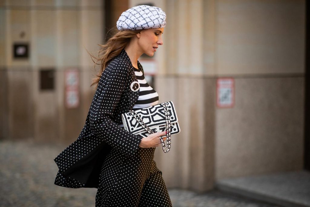 Chanel, Steffen Schraut, Manolo Blahnik Alexandra Lapp in a tweed beret dot suit look, wearing a long black blazer with dots and matching culotte pants, black and white striped sweater with a yellow detail from Steffen Schraut, a black and white tweed beret from the Chanel La Pausa collection, a black and white 2.55 flap bag from Chanel during the Berlin Fashion Week Autumn/Winter 2019 on January 16, 2019 in Berlin, Germany. (Photo by Christian Vierig/Getty Images)