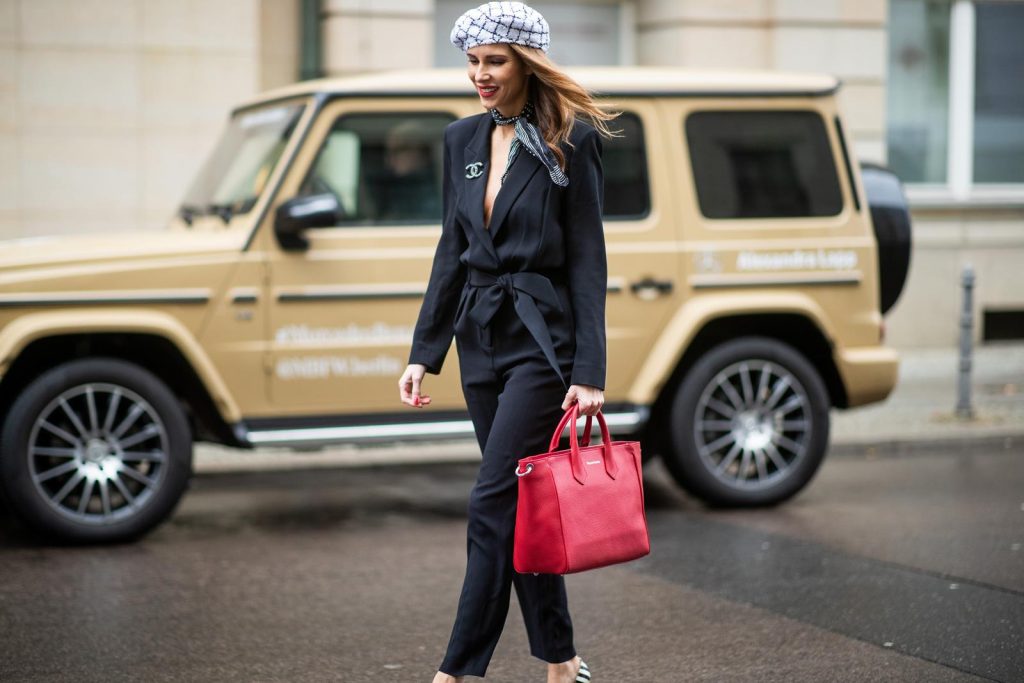 Alexandra Lapp in a Carrierista look, wearing the black IRO Delicate jumpsuit, styled with a Chanel logo brooch, black and white Chanel tweed beret of the la pause collection, a vintage dotted silk foulard tied around the neck, black and white striped So Kate patent leather pumps by Christian Louboutin and the VOLLENWEIDER Business bag CARRIERISTA in rosso during the Berlin Fashion Week Autumn/Winter 2019 on January 15, 2019 in Berlin, Germany. (Photo by Christian Vierig/Getty Images)