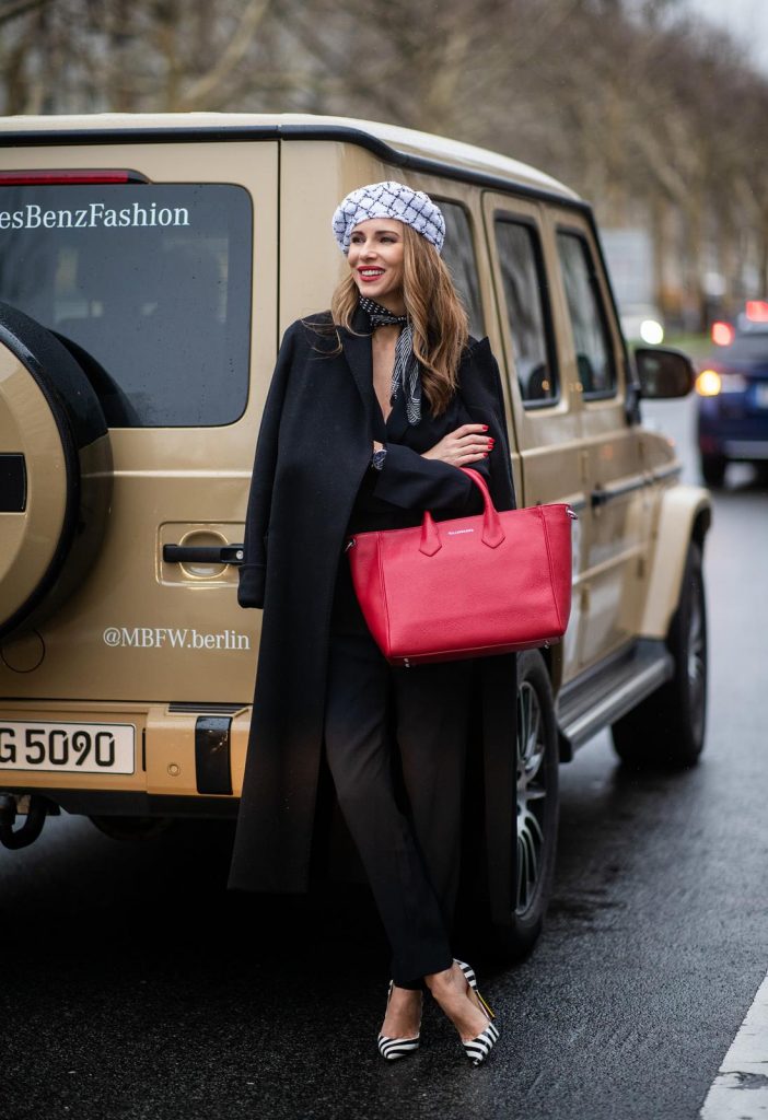Alexandra Lapp in a Carrierista look, wearing the black IRO Delicate jumpsuit, styled with a Chanel logo brooch, black and white Chanel tweed beret of the la pause collection, a vintage dotted silk foulard tied around the neck, black and white striped So Kate patent leather pumps by Christian Louboutin and the VOLLENWEIDER Business bag CARRIERISTA in rosso during the Berlin Fashion Week Autumn/Winter 2019 on January 15, 2019 in Berlin, Germany. (Photo by Christian Vierig/Getty Images)