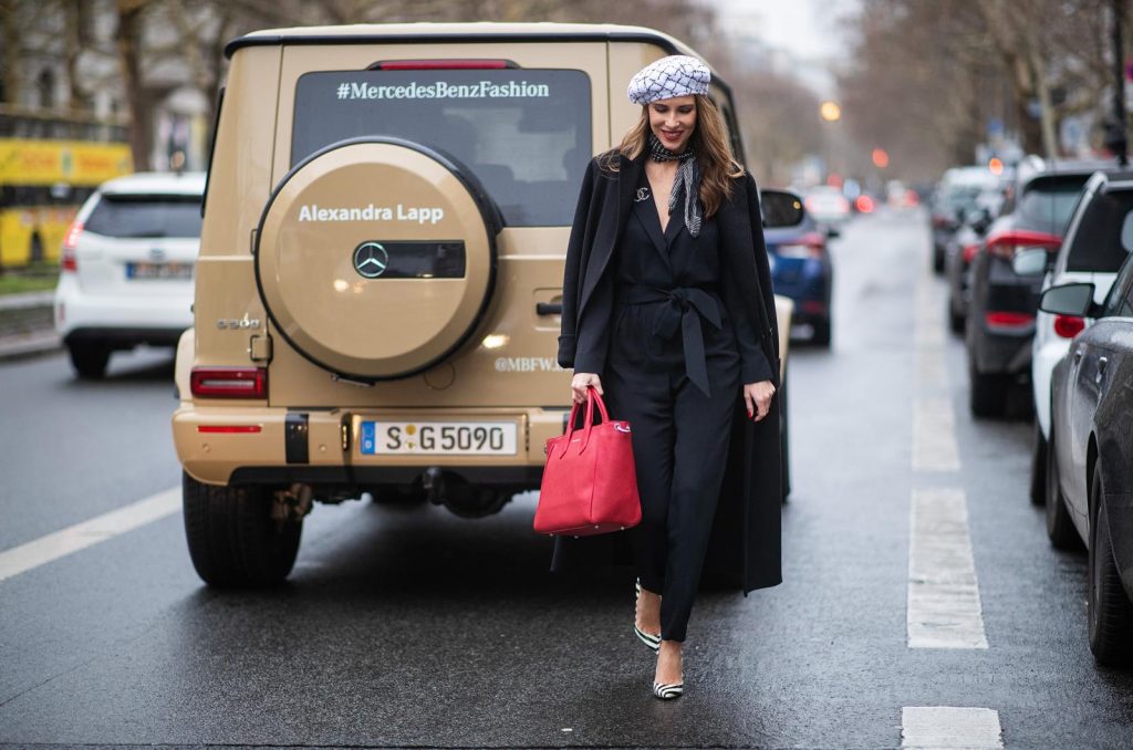 Alexandra Lapp in a Carrierista look, wearing the black IRO Delicate jumpsuit, styled with a Chanel logo brooch, black and white Chanel tweed beret of the la pause collection, a vintage dotted silk foulard tied around the neck, black and white striped So Kate patent leather pumps by Christian Louboutin and the VOLLENWEIDER Business bag CARRIERISTA in rosso during the Berlin Fashion Week Autumn/Winter 2019 on January 15, 2019 in Berlin, Germany. (Photo by Christian Vierig/Getty Images)