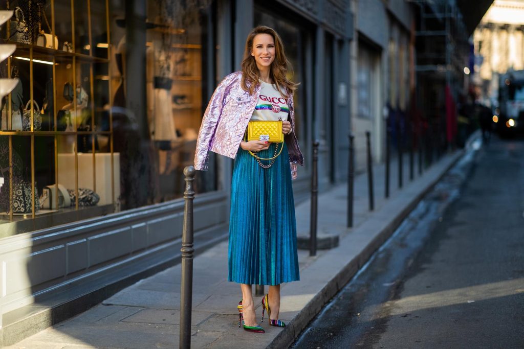 Sies Marjan, ROQA, Gucci, Chanel, Christian Louboutin, Céline Alexandra Lapp in a Metallic Fashion look, wearing the crinkled Alby laminated jacket from Sies Marjan, a pleated metallic skirt from ROQA in turquoise, a white logo print Gucci t-shirt, Chanel Boy bag in gold, Audrey sunglasses from Celine during Paris Fashion Week Womenswear Fall/Winter 2019/2020 on February 25, 2019 in Paris, France. (Photo by Christian Vierig/Getty Images)