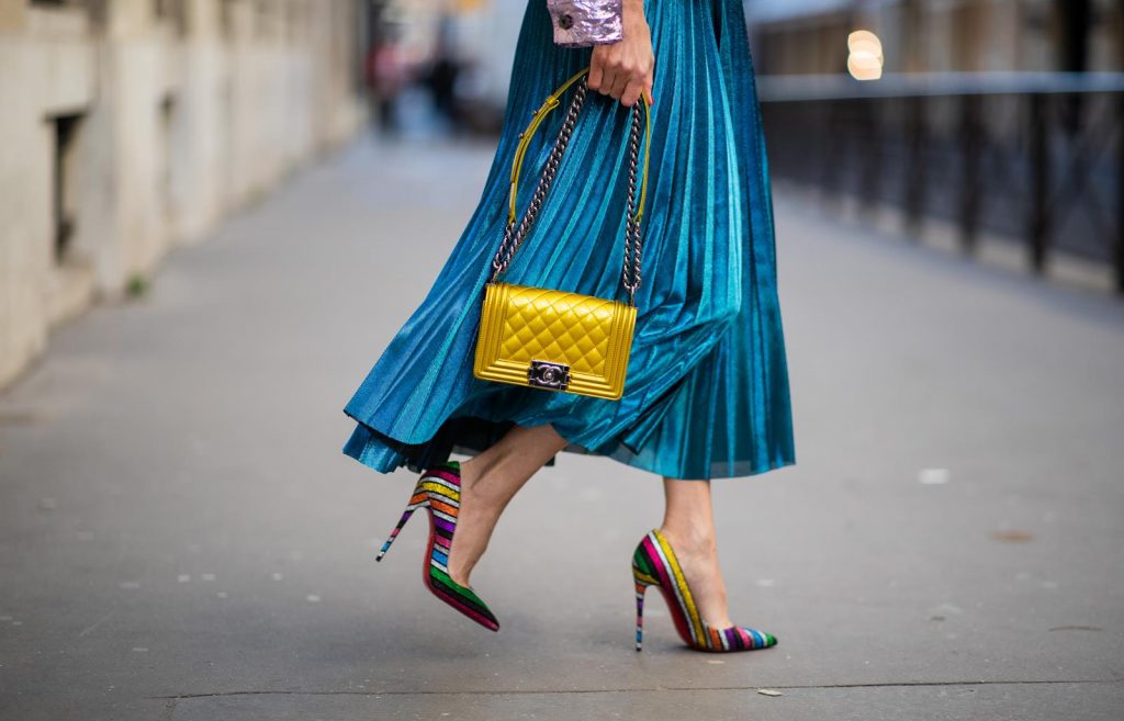Sies Marjan, ROQA, Gucci, Chanel, Christian Louboutin, Céline Alexandra Lapp in a Metallic Fashion look, wearing the crinkled Alby laminated jacket from Sies Marjan, a pleated metallic skirt from ROQA in turquoise, a white logo print Gucci t-shirt, Chanel Boy bag in gold, Audrey sunglasses from Celine during Paris Fashion Week Womenswear Fall/Winter 2019/2020 on February 25, 2019 in Paris, France. (Photo by Christian Vierig/Getty Images)