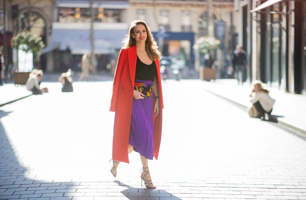 Alexandra Lapp in a Color Flash look, wearing a red Givenchy long coat, a purple Balenciaga plissée skirt, Off-white stretch top, pointed Gianvito Rossi sandals in black, Balenciaga BB printed velvet clutch all from Breuninger during Paris Fashion Week Womenswear Fall/Winter 2019/2020 on February 26, 2019 in Paris, France. (Photo by Christian Vierig/Getty Images)