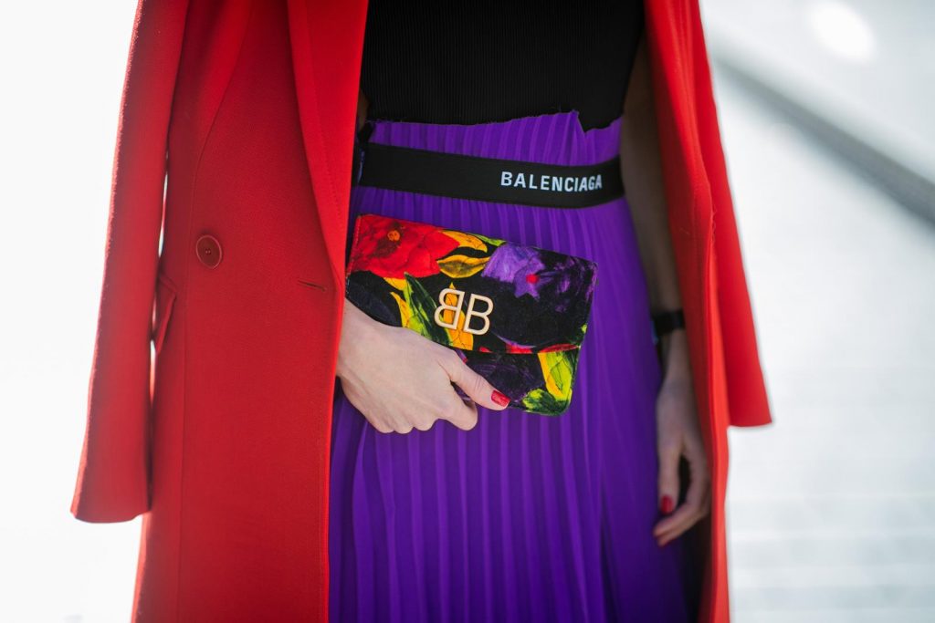 Alexandra Lapp in a Color Flash look, wearing a red Givenchy long coat, a purple Balenciaga plissée skirt, Off-white stretch top, pointed Gianvito Rossi sandals in black, Balenciaga BB printed velvet clutch all from Breuninger during Paris Fashion Week Womenswear Fall/Winter 2019/2020 on February 26, 2019 in Paris, France. (Photo by Christian Vierig/Getty Images)