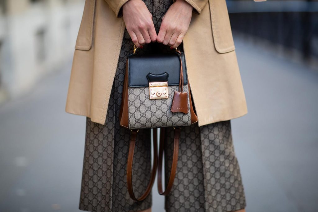 Alexandra Lapp in a Gucci culotte pants look, wearing the Culottes with monogram pattern, brown and black Gucci backpack with monogram pattern, a sparkling white swimsuit with the Gucci logo print, vintage leather Trenchcoat from Gucci, So Kate Christian Louboutin heels in cognac during Paris Fashion Week Womenswear Fall/Winter 2019/2020 on February 25, 2019 in Paris, France. (Photo by Christian Vierig/Getty Images)