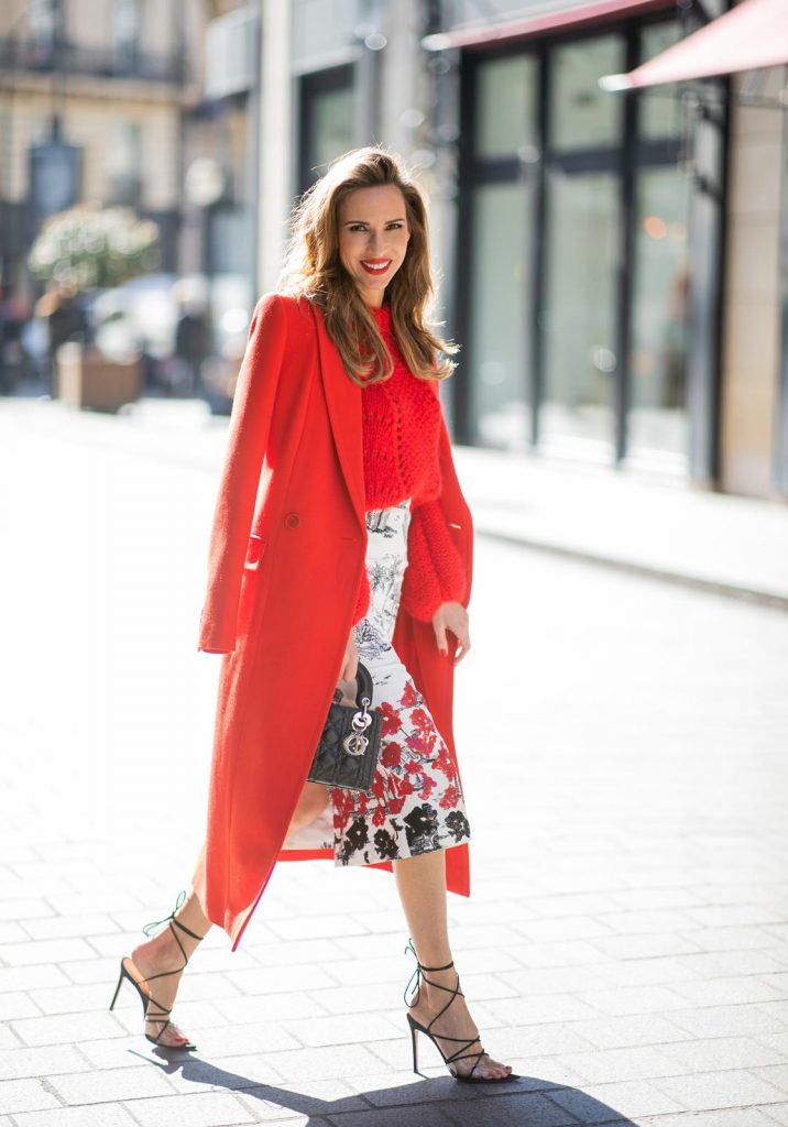 Alexandra Lapp in a Printed Skirt look, wearing a fitted two button coat in bright red from Givenchy, with a NO.21 sequined twill pencil skirt with a Palm-print, a red wool loose knit sweater from Ganni - all from Breuninger, black sandals from Gianvito Rossi, Prada cat-eye shaped sunglasses with red details and the Lady Dior mini bag during Paris Fashion Week Womenswear Fall/Winter 2019/2020 on February 26, 2019 in Paris, France. (Photo by Christian Vierig/Getty Images)