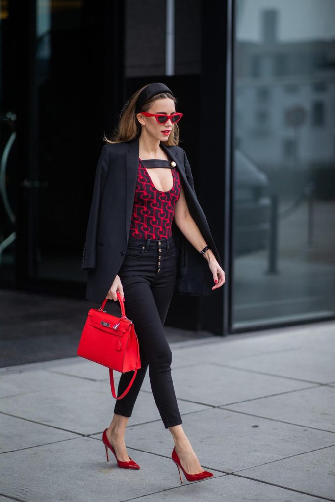 Alexandra Lapp in a Prada Bodysuit look wearing the SS19 black and red Prada Jacquard Jersey Body, black satin headband by Prada, red Hermes Kelly bag, red Cat-eye Celine sunglasses, Saint Laurent black classic jacket, Veronica Beard Debbie jeans in black on May 03, 2019 in Duesseldorf, Germany. (Photo by Christian Vierig/Getty Images)