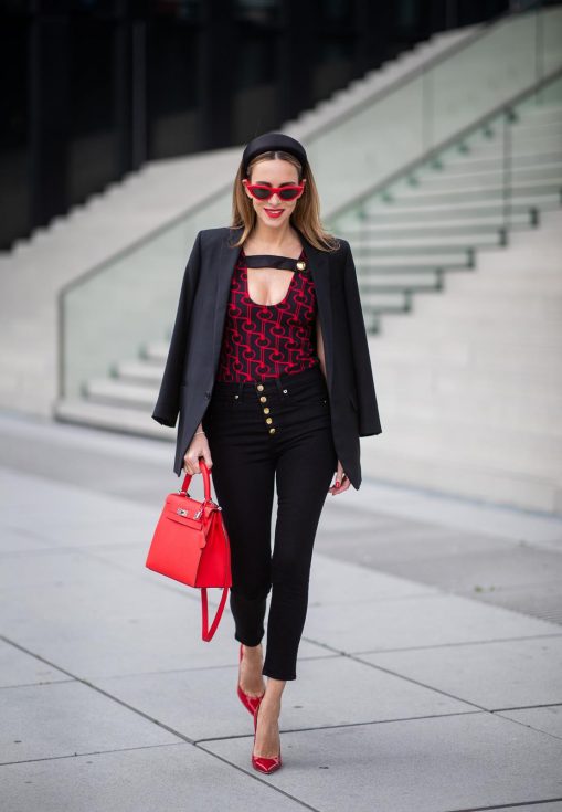 Alexandra Lapp in a Prada Bodysuit look wearing the SS19 black and red Prada Jacquard Jersey Body, black satin headband by Prada, red Hermes Kelly bag, red Cat-eye Celine sunglasses, Saint Laurent black classic jacket, Veronica Beard Debbie jeans in black on May 03, 2019 in Duesseldorf, Germany. (Photo by Christian Vierig/Getty Images)