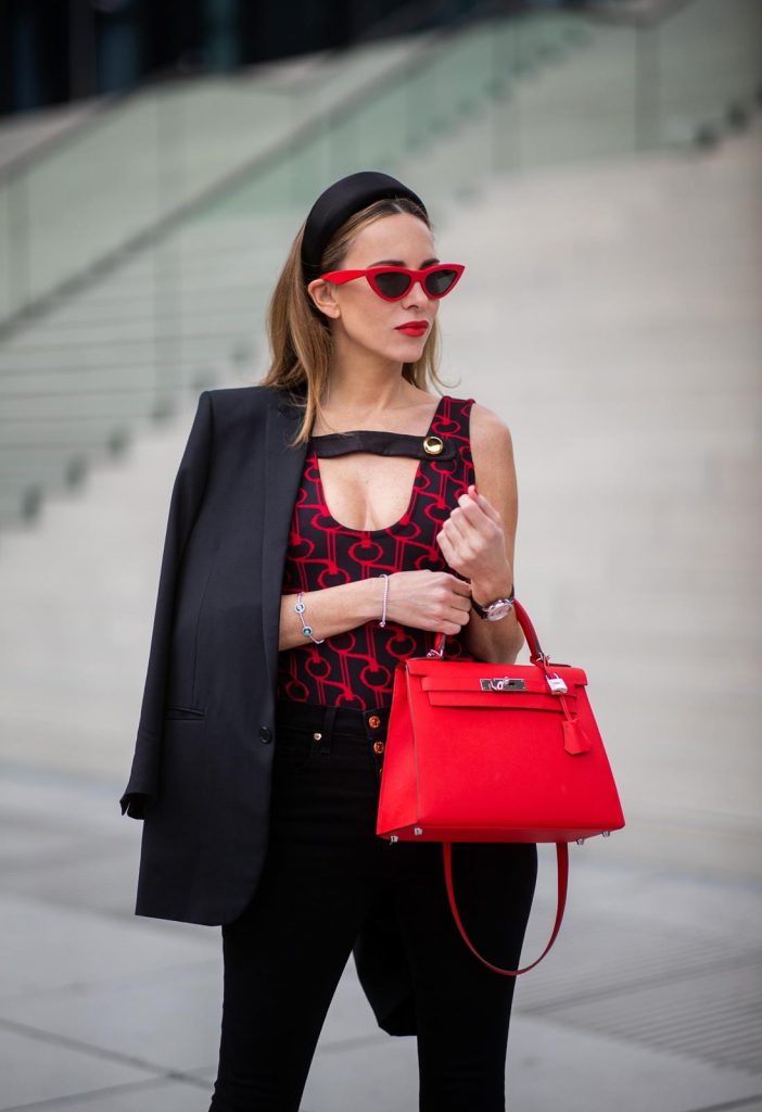 Alexandra Lapp in a Prada Bodysuit look wearing the SS19 black and red Prada Jacquard Jersey Body, black satin headband by Prada, red Hermes Kelly bag, red Cat-eye Celine sunglasses, Saint Laurent black classic jacket, Veronica Beard Debbie jeans in black on May 03, 2019 in Duesseldorf, Germany. (Photo by Christian Vierig/Getty Images)