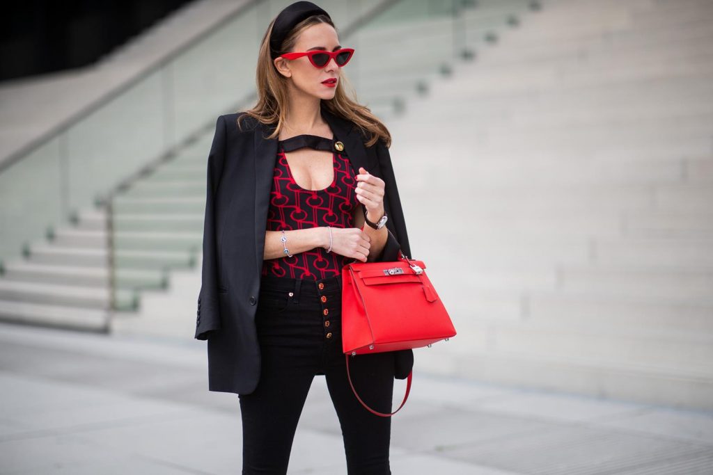 Alexandra Lapp in a Prada Bodysuit look wearing the SS19 black and red Prada Jacquard Jersey Body, black satin headband by Prada, red Hermes Kelly bag, red Cat-eye Celine sunglasses, Saint Laurent black classic jacket, Veronica Beard Debbie jeans in black on May 03, 2019 in Duesseldorf, Germany. (Photo by Christian Vierig/Getty Images)