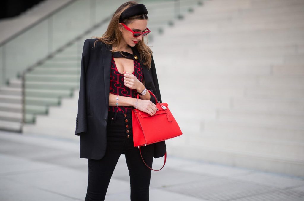 Alexandra Lapp in a Prada Bodysuit look wearing the SS19 black and red Prada Jacquard Jersey Body, black satin headband by Prada, red Hermes Kelly bag, red Cat-eye Celine sunglasses, Saint Laurent black classic jacket, Veronica Beard Debbie jeans in black on May 03, 2019 in Duesseldorf, Germany. (Photo by Christian Vierig/Getty Images)