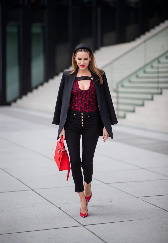 Alexandra Lapp in a Prada Bodysuit look wearing the SS19 black and red Prada Jacquard Jersey Body, black satin headband by Prada, red Hermes Kelly bag, red Cat-eye Celine sunglasses, Saint Laurent black classic jacket, Veronica Beard Debbie jeans in black on May 03, 2019 in Duesseldorf, Germany. (Photo by Christian Vierig/Getty Images)