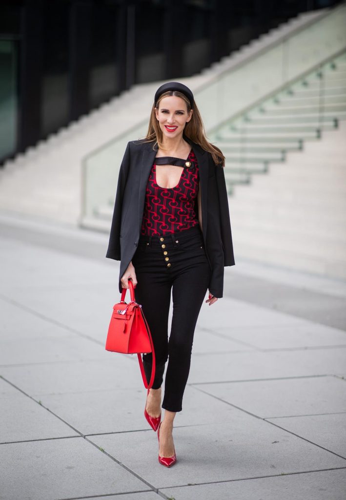 Alexandra Lapp in a Prada Bodysuit look wearing the SS19 black and red Prada Jacquard Jersey Body, black satin headband by Prada, red Hermes Kelly bag, red Cat-eye Celine sunglasses, Saint Laurent black classic jacket, Veronica Beard Debbie jeans in black on May 03, 2019 in Duesseldorf, Germany. (Photo by Christian Vierig/Getty Images)