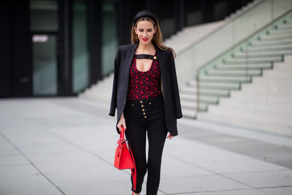 Alexandra Lapp in a Prada Bodysuit look wearing the SS19 black and red Prada Jacquard Jersey Body, black satin headband by Prada, red Hermes Kelly bag, red Cat-eye Celine sunglasses, Saint Laurent black classic jacket, Veronica Beard Debbie jeans in black on May 03, 2019 in Duesseldorf, Germany. (Photo by Christian Vierig/Getty Images)