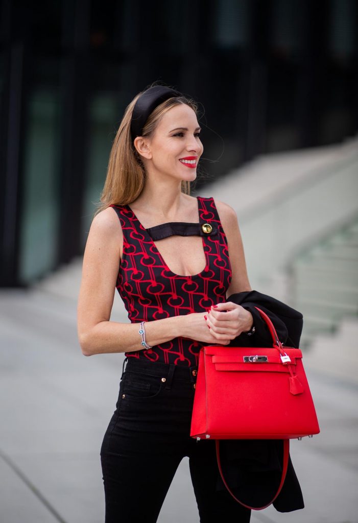 Alexandra Lapp in a Prada Bodysuit look wearing the SS19 black and red Prada Jacquard Jersey Body, black satin headband by Prada, red Hermes Kelly bag, red Cat-eye Celine sunglasses, Saint Laurent black classic jacket, Veronica Beard Debbie jeans in black on May 03, 2019 in Duesseldorf, Germany. (Photo by Christian Vierig/Getty Images)