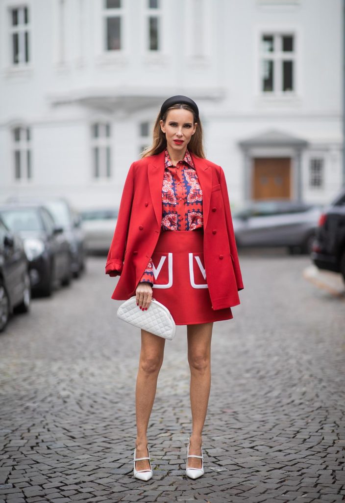 Alexandra Lapp in a Valentino Look, wearing a short red wool skirt with the embroidered V Logo, with a matching long oversized blazer, a logo printed twill shirt in blue white and red- all from Valentino, a black silk satin headband from Prada on May 01, 2019 in Duesseldorf, Germany. (Photo by Christian Vierig/Getty Images)