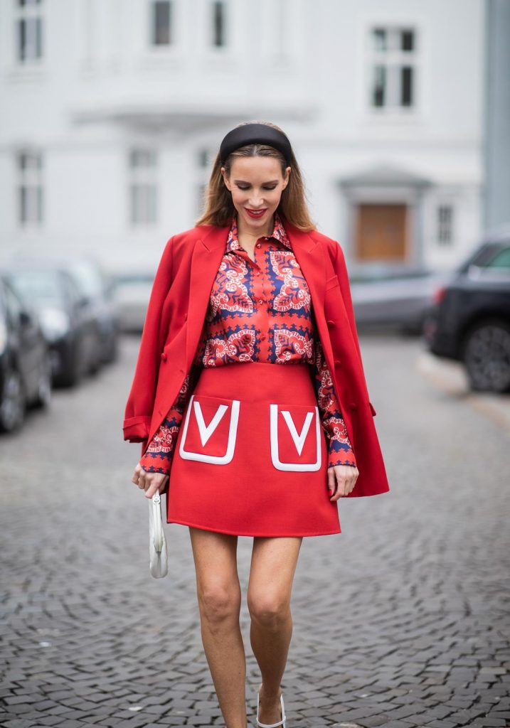 Alexandra Lapp in a Valentino Look, wearing a short red wool skirt with the embroidered V Logo, with a matching long oversized blazer, a logo printed twill shirt in blue white and red- all from Valentino, a black silk satin headband from Prada on May 01, 2019 in Duesseldorf, Germany. (Photo by Christian Vierig/Getty Images)