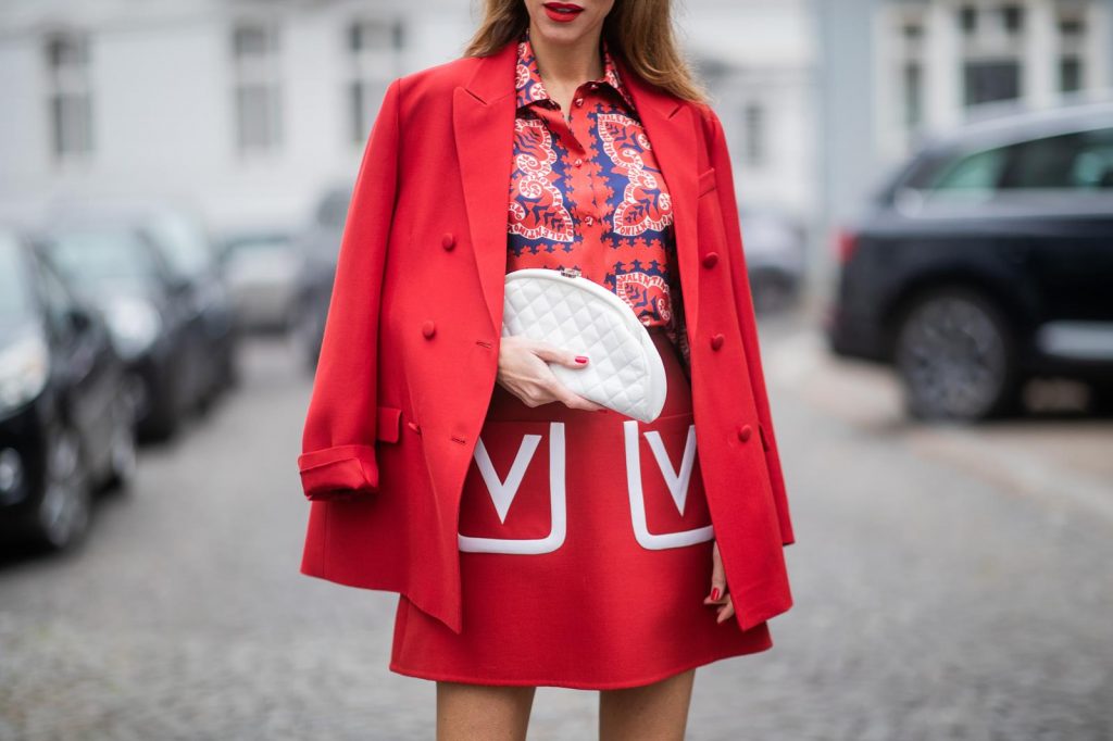 Alexandra Lapp in a Valentino Look, wearing a short red wool skirt with the embroidered V Logo, with a matching long oversized blazer, a logo printed twill shirt in blue white and red- all from Valentino, a black silk satin headband from Prada on May 01, 2019 in Duesseldorf, Germany. (Photo by Christian Vierig/Getty Images)
