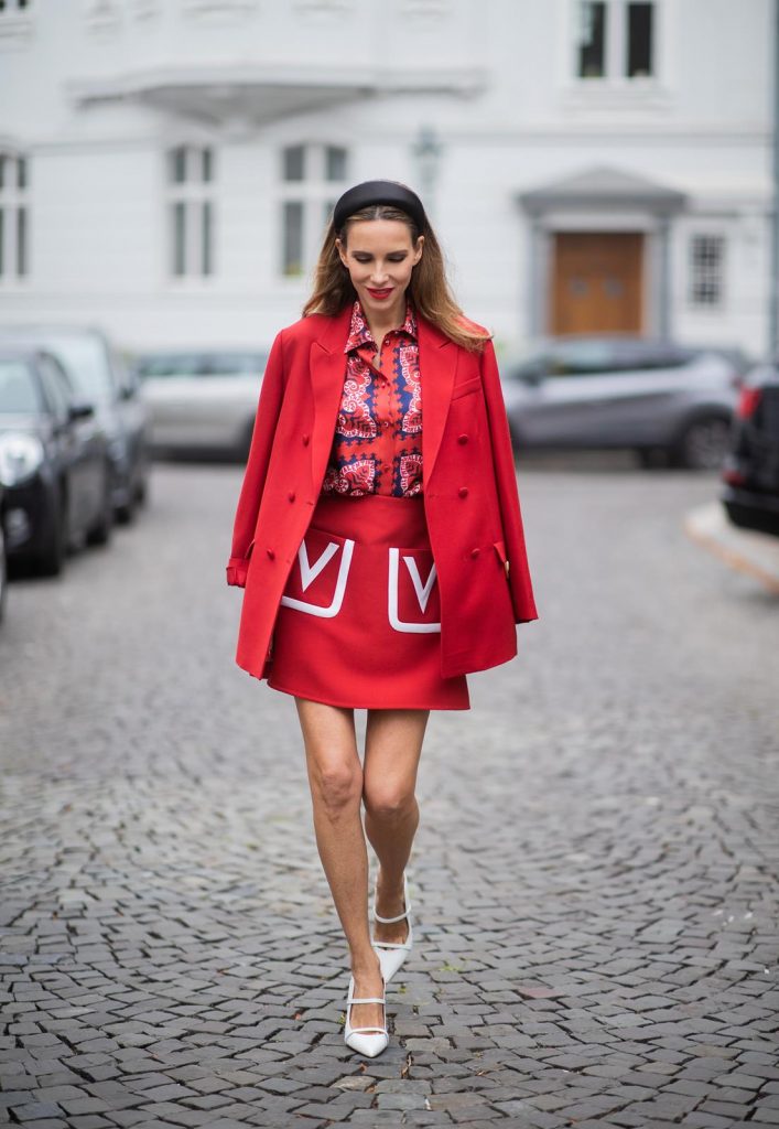 Alexandra Lapp in a Valentino Look, wearing a short red wool skirt with the embroidered V Logo, with a matching long oversized blazer, a logo printed twill shirt in blue white and red- all from Valentino, a black silk satin headband from Prada on May 01, 2019 in Duesseldorf, Germany. (Photo by Christian Vierig/Getty Images)