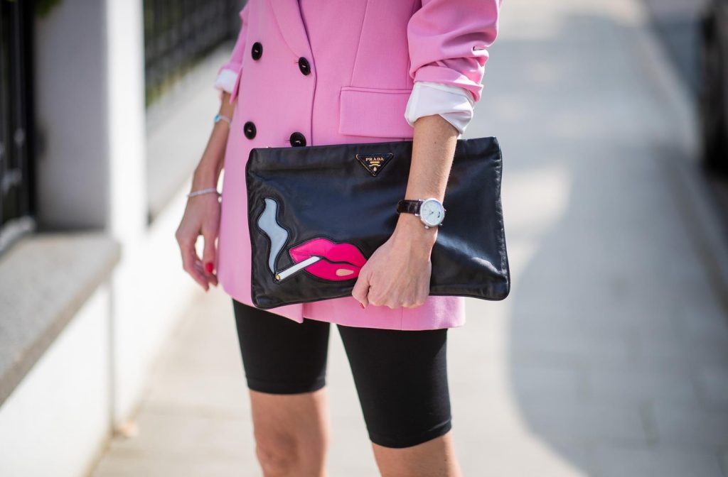 Alexandra Lapp in a cycling pants look, wearing a pink oversized blazer from Zara, a logo print t-shirt in black and white from Balenciaga, biker / cycling shorts from H&M, a pink silk satin hairband from Prada, a black clutch with a smoking red mouth print from Prada and the black pointed BB pumps from Balenciaga on May 04, 2019 in Duesseldorf, Germany. (Photo by Christian Vierig/Getty Images)