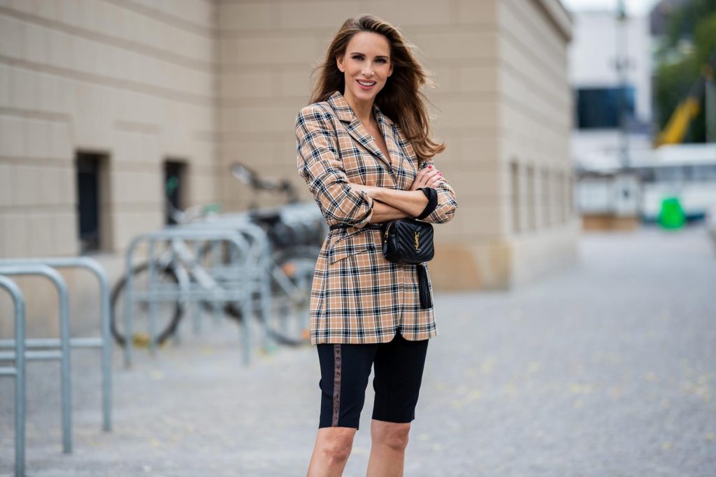 Alexandra Lapp is seen wearing a beige brown checkered blazer, black cycling pants and black bucket hat from Riani, Céline Audrey sunglasses, black St. Laurent Lou belt bag and black Gianvito Rossi patent leather pumps during Berlin Fashion Week on July 02, 2019 in Berlin, Germany. (Photo by Christian Vierig/Getty Images)