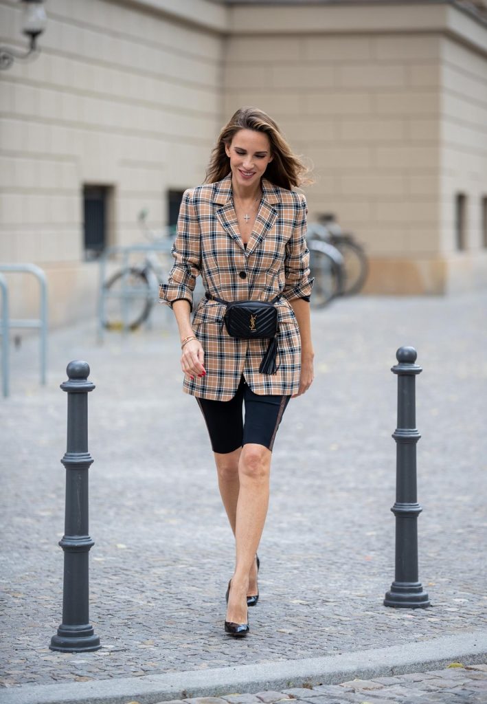 Alexandra Lapp is seen wearing a beige brown checkered blazer, black cycling pants and black bucket hat from Riani, Céline Audrey sunglasses, black St. Laurent Lou belt bag and black Gianvito Rossi patent leather pumps during Berlin Fashion Week on July 02, 2019 in Berlin, Germany. (Photo by Christian Vierig/Getty Images)