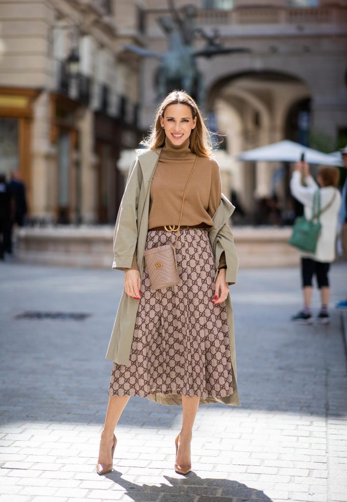 PARIS, FRANCE - SEPTEMBER 23:Blogger, Model and Influencer Alexandra Lapp is seen wearing a Gucci GG pleated jersey midi skirt, GG Marmont Mini-Bucket bag in nude, Christian Louboutin So Kate pumps in camel, camel Nili Lotan sweater, beige Zara trenchcoat during Paris Fashion Week Womenswear Spring Summer 2020 on September 23, 2019 in Paris, France. 