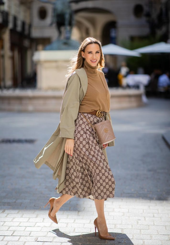 PARIS, FRANCE - SEPTEMBER 23:Blogger, Model and Influencer Alexandra Lapp is seen wearing a Gucci GG pleated jersey midi skirt, GG Marmont Mini-Bucket bag in nude, Christian Louboutin So Kate pumps in camel, camel Nili Lotan sweater, beige Zara trenchcoat during Paris Fashion Week Womenswear Spring Summer 2020 on September 23, 2019 in Paris, France. 