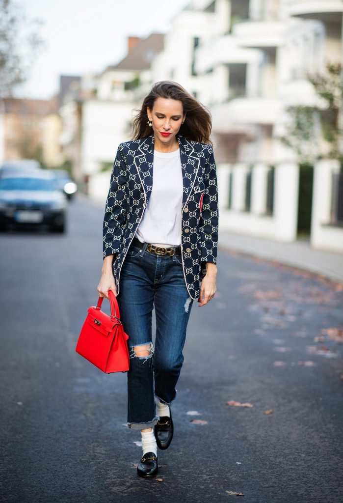 college look, Gucci, AG Denim, Adriano Goldschmied, Gucci loafers, Falke, Dior, The Frankie Shop, Hermes, Kelly bag DUESSELDORF, GERMANY - DECEMBER 11: Alexandra Lapp is seen wearing a college look, dark denim blue jeans AG Jeans, white sleeveless muscle tshirt with padded shoulders The Frankie Shop, Gucci GG horsebit leather belt, Gucci college jacket with logo print, red Hermes Kelly bag on December 11, 2019 in Duesseldorf, Germany. (Photo by Christian Vierig/Getty Images)