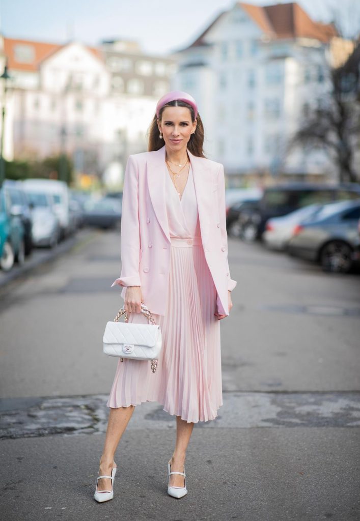 DUESSELDORF, GERMANY : Alexandra Lapp is seen wearing a monochrome look Riani, pink pleated dress, pink oversized blazer, white Chanel bag on December 11, 2019 in Duesseldorf, Germany. (Photo by Christian Vierig/Getty Images)