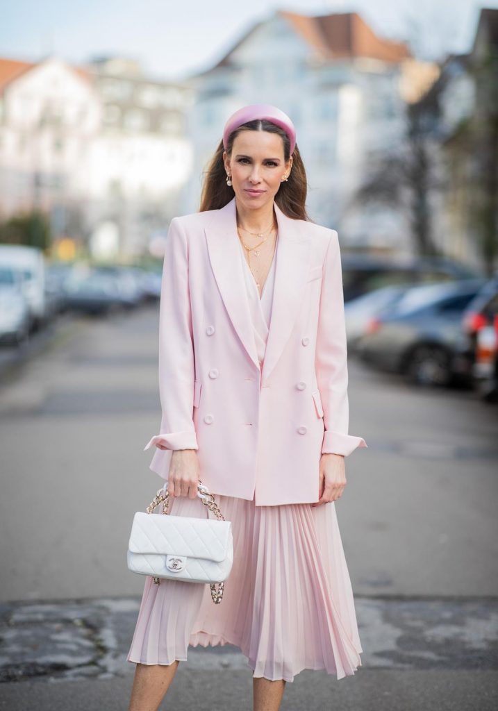 DUESSELDORF, GERMANY : Alexandra Lapp is seen wearing a monochrome look Riani, pink pleated dress, pink oversized blazer, white Chanel bag on December 11, 2019 in Duesseldorf, Germany. (Photo by Christian Vierig/Getty Images)