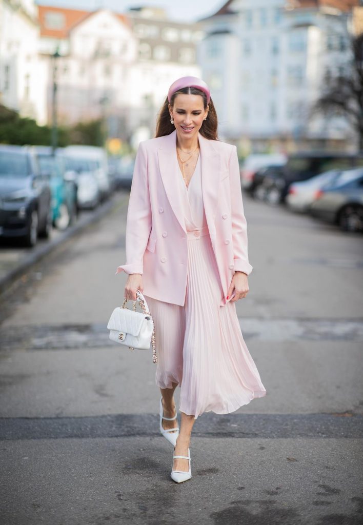 DUESSELDORF, GERMANY : Alexandra Lapp is seen wearing a monochrome look Riani, pink pleated dress, pink oversized blazer, white Chanel bag on December 11, 2019 in Duesseldorf, Germany. (Photo by Christian Vierig/Getty Images)